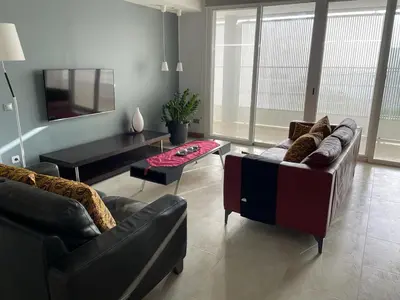 a living room with two couches and a tv at Marimar in Praia