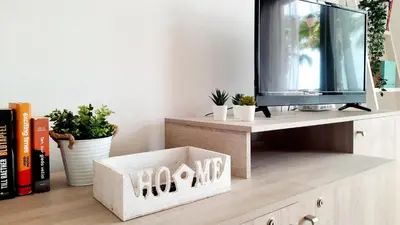 a tv sitting on top of a cabinet with plants at Sunshine home Sal in Santa Maria