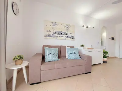 a living room with a couch with two pillows on it at Sunshine home Sal in Santa Maria