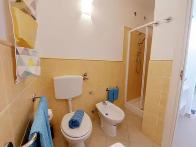a bathroom with a toilet and a sink and a shower at Sunshine home Sal in Santa Maria