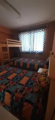 a bedroom with a bed with a quilt on it at Atlantic Maio Hotel in Vila do Maio
