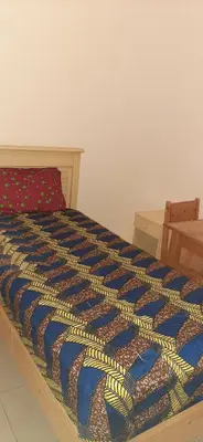 a bed with a colorful comforter on top of it at Atlantic Maio Hotel in Vila do Maio