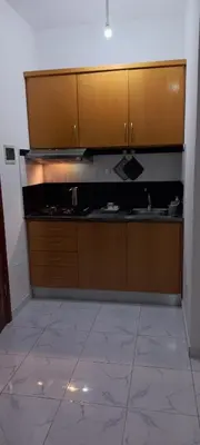a kitchen with wooden cabinets and a sink at Ka-Bela 2 in Sal Rei