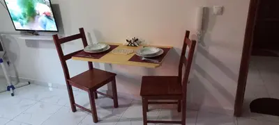 a wooden table with two chairs and a plate on it at Ka-Bela 2 in Sal Rei