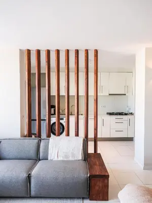 a living room with a couch and a kitchen at Madeira apartment in Mindelo São Vicente in Mindelo