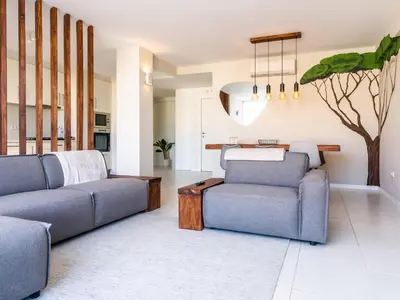 a living room with two couches and a table at Madeira apartment in Mindelo São Vicente in Mindelo