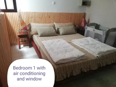 a bedroom with a bed with air conditioning and window at Casa Privada do Plateau in Praia