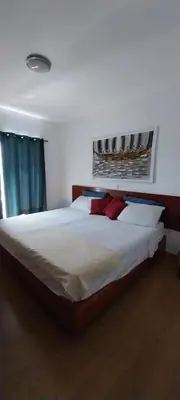 a bedroom with a large white bed with red pillows at Ca’ Tina in Santa Maria