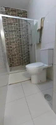 a white bathroom with a toilet and a shower at Ca’ Tina in Santa Maria