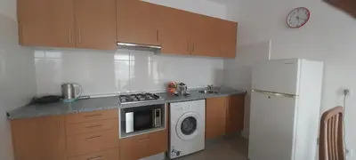 a kitchen with a stove and a washing machine at Ca’ Tina in Santa Maria
