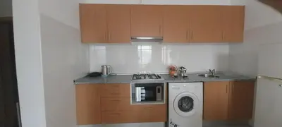 a kitchen with a stove and a washing machine at Ca’ Tina in Santa Maria