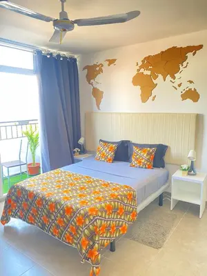 a bedroom with a bed with a map on the wall at Quarto Nº5 FANTASTIQUE- Central Praia in Praia