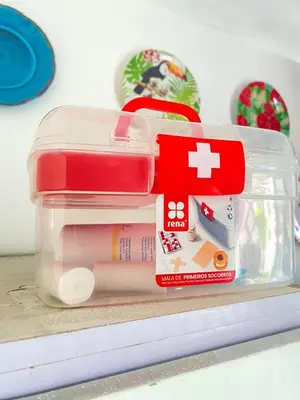 a plastic container filled with medicines on a shelf at Quarto Nº7 FAMILIA VEIGA - Central Praia in Praia