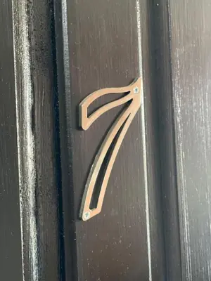 a metal door with a black and white handle at Quarto Nº7 FAMILIA VEIGA - Central Praia in Praia