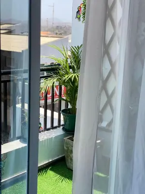 a balcony with potted plants and a window at Quarto Nº7 FAMILIA VEIGA - Central Praia in Praia