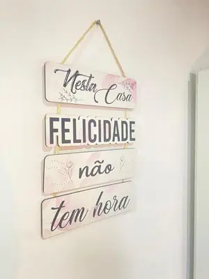 a group of signs hanging on a wall at Quarto Nº8 LUMA - Central Praia in Praia