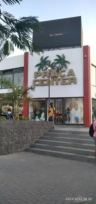 a person standing in front of a store at Praia Center in Praia