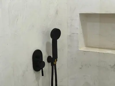 a black hair brush hanging on a wall at Leme Bedje Sea View - By Bobbywashere in Santa Maria