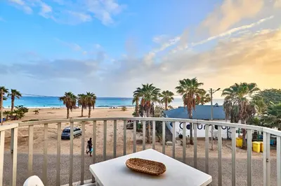 a table on a balcony with a view of the beach at Leme Bedje Sea View - By Bobbywashere in Santa Maria