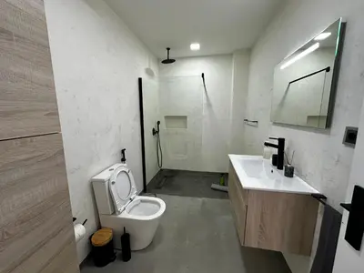a bathroom with a toilet and a sink and a shower at Leme Bedje Sea View - By Bobbywashere in Santa Maria