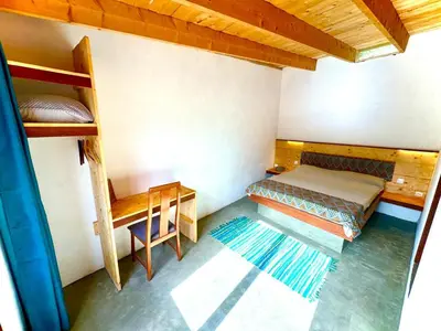 a room with two bunk beds and a desk at Villa Morabeza Guest House in Mindelo
