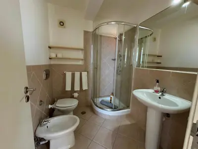 a bathroom with a shower and a toilet and a sink at Leme Bedje Three bedroom - By Bobbywashere in Santa Maria