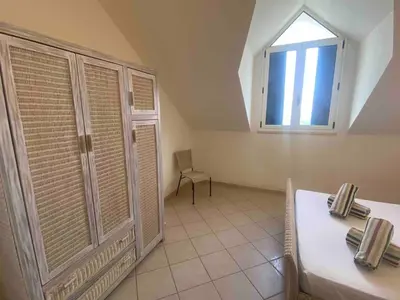 a dining room with a table and a window at Leme Bedje Two bedroom - By Bobbywashere in Santa Maria