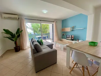 a living room with a couch and a table at Leme Bedje Two bedroom - By Bobbywashere in Santa Maria