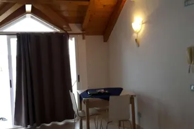 a room with a table and chairs and a window at Holiday Properties Soleil Penthouse in Santa Maria
