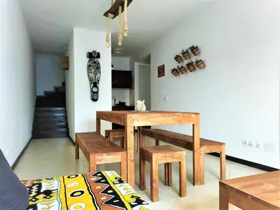 a dining room with a wooden table and benches at Solstice in Santa Maria