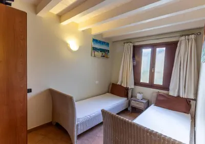 a room with two beds and a window at Porto Antigo 1 - Three bedroom, pool & wifi in Santa Maria