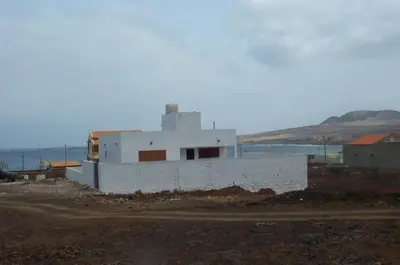 a white building in the middle of a field at Villa Calhau in Mindelo