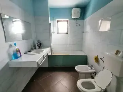 a bathroom with a tub and a toilet and a sink at Villa Calhau in Mindelo