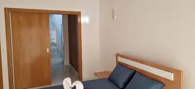 a bedroom with a bed and a door to a bathroom at PIMONTAPARTMENTS in Espargos