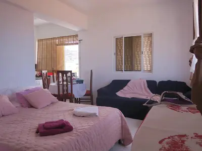 a bedroom with two beds and a couch at Casa de Nômades Digitais in Mindelo