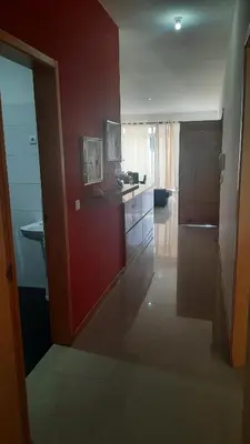 a kitchen with a red wall and a sink at My Flat 2 in Praia