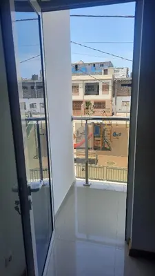 a room with a window with a view of a building at My Flat 2 in Praia