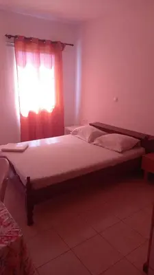 a bedroom with a large bed with a window at SAM House in Mindelo