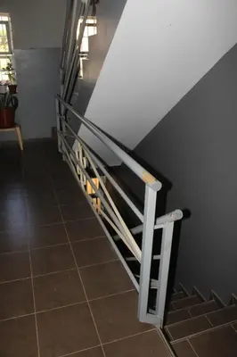 a staircase with a metal railing next to a tile floor at SAM House in Mindelo