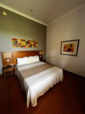 a bedroom with a large bed in a room at Bamboo Xaguate Hotel in São Filipe