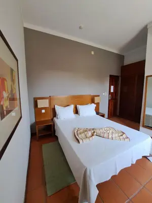 a bedroom with a large white bed in a room at Bamboo Xaguate Hotel in São Filipe