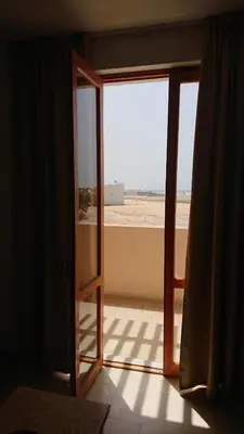 an open door with a view of the beach at Residence Estrela do Mar in Sal Rei
