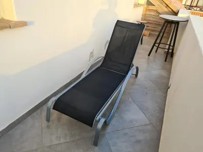 a black chair sitting next to a wall at Plaza Top floor apartment in Santa Maria