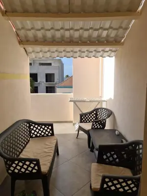 a patio with chairs and a table and a window at Plaza Top floor apartment in Santa Maria