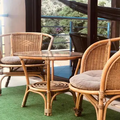 a group of chairs and a table on a porch at Finca Pedra Molar in Órgãos