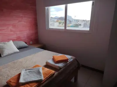 a bedroom with a bed with towels on it at Studio Maya Mindelo in Mindelo