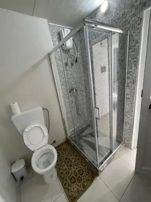 a bathroom with a shower and a toilet at Apartamento in Praia