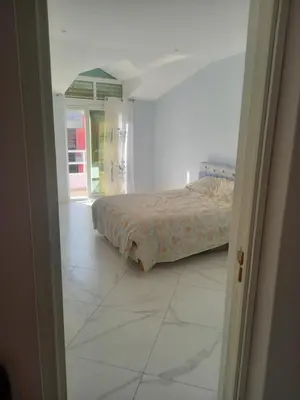 a bedroom with a bed and a tiled floor at CHEZ LU & LUCIO in Assomada