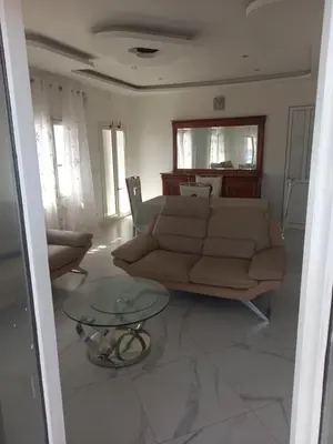 a living room with a couch and a glass table at CHEZ LU & LUCIO in Assomada