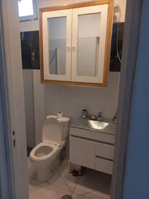 a bathroom with a toilet and a sink and a mirror at CHEZ LU & LUCIO in Assomada